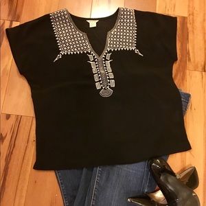 Black blouse with white detail.
